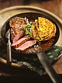 Medium duck breast with red wine sauce and potato fritters