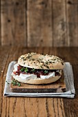 A bagel with cream cheese and red onion chutney