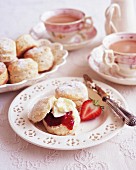 Scones with clotted cream and strawberry jam served with tea