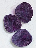 Halved purple potatoes (seen from above)