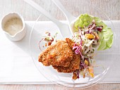 Mini escalopes with a sesame seed coating served with mango & cabbage salad