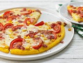 Polenta pizza with salami and sweetcorn