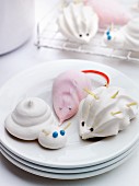 Animal meringues on plates and a cooling rack