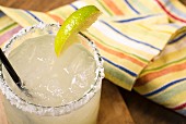 Margarita in a glass with a slice of lime and a salt-coated rim
