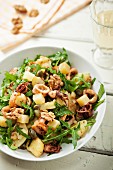 Squid salad with potatoes, rocket and walnuts