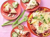 Pitta bread pizzas with peppers, tomatoes, ham and cheese