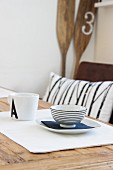 Breakfast place setting of bowl and plate on wooden table