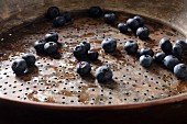 Freshly washed blueberries in a metal colander