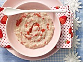 Strawberry porridge with baby oat flakes