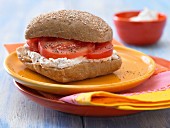 A savoury quark & cream cheese bread roll with tomato