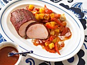 Roast pork with a tomato crust and potatoes with red pepper