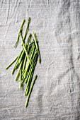 Green asparagus spears on a grey surface