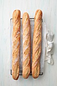 Three baguettes on a cooling rack