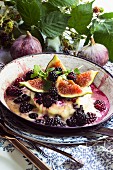 Melted cheese with berries and figs in a pan