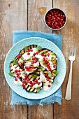 Grilled aubergine slices with yoghurt and pomegranate seeds