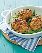 Hasselback potatoes with onion sauce and rocket