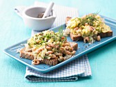 Scrambled egg with shrimps on toast with dill and fennel
