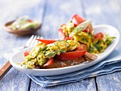 Scrambled egg with herbs on tomato baguette