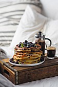 Breakfast in bed with waffles, berries and coffee