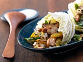 Hot Chinese cabbage wraps with turkey strips, peppers and mushrooms