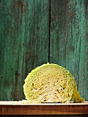 Half a savoy cabbage on a wooden board