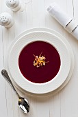Borscht (beetroot soup) with almond flakes and orange zest