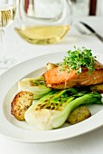 Salmon on grilled pak choy with fried potatoes