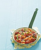 Spicy pasta with pork sausage balls, tomato and basil