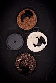 Various types of rice in pans (seen from above)