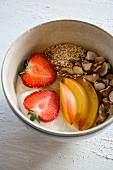 A breakfast bowl with amaranth, yoghurt, fruit and hazelnuts