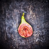 Half a red fig on a metal surface (seen from above)