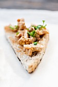 A slice of bread with chanterelle mushrooms and sour cream
