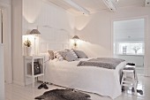 White and grey bedroom with wooden floor and ceiling