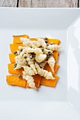Lukewarm Japanese artichoke salad with capers on a bed of pumpkin