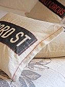 Vintage-style cushions cover with appliqué lettering