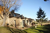 Rustic stone house surrounded by autumnal garden