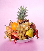 A fruit arrangement with pineapple and dates