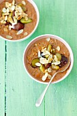 Chocolate porridge with flaked almonds and plums