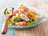 Seafood salad with tomato, yellow pepper and celery