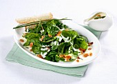 Baby leaf spinach with cheese sauce and flaked almonds