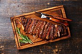 Sliced grilled beef barbecue Striploin steak on cutting board