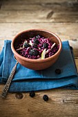 Red cabbage & blackberry coleslaw on a wooden table