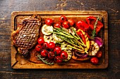 Grilled Black Angus Steak Striploin and vegetables on cutting board