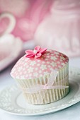 Cupcake decorated with patterned fondant and a sugar flower