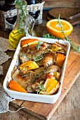 Roast chicken thighs with orange wedges and rosemary