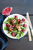 A rocket salad with raspberries, pan-fried chicken liver, flaked almonds and raspberry dressing