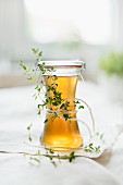 Home-made thyme syrup and sprigs of thyme