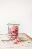 A glass jar filled with boiled sweets (French poppy sweets)