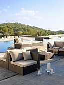 Modern lounge furniture on concrete floor next to pool