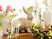 Easter arrangement with bottles used as vases and bunny ornament